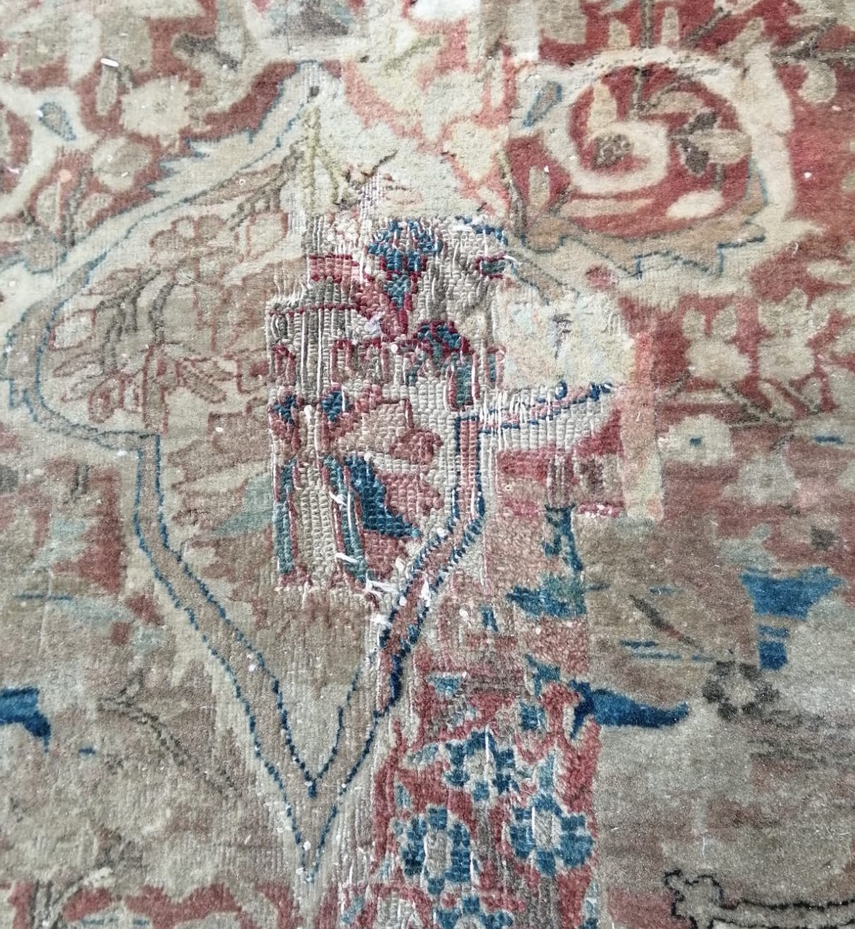 A fine Persian cream ground carpet, in distressed condition, 360 x 300cm